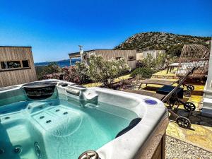 a jacuzzi tub with a view of the ocean at Ferienhaus mit Privatpool für 4 Personen ca 54 qm in Drage, Dalmatien Norddalmatien in Drage