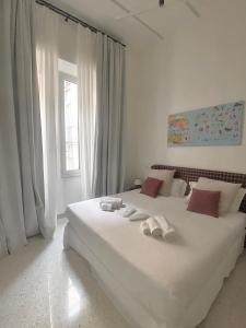 a bedroom with a large white bed with towels on it at Veneto Suite 2 by SupaStays - King room in Rome