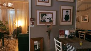 a living room with a table and pictures on the wall at Hotel Nizza Creative Hotel in Rimini