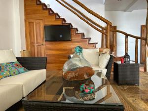 a living room with a couch and a glass table at VILLA FLOREANA in Puerto Velasco Ibarra