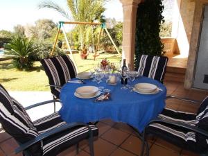 a table with a blue table cloth on a patio at Ferienhaus mit Privatpool für 6 Personen ca 130 m in Sencelles, Balearen Mallorca in Sencelles