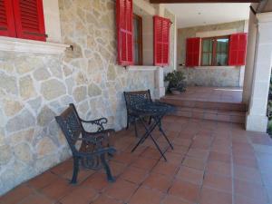 two chairs and a table on a patio with red shutters at Ferienhaus mit Privatpool für 6 Personen ca 130 m in Sencelles, Balearen Mallorca in Sencelles +8 photos