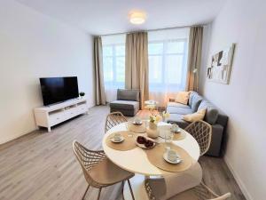 a living room with a table and a couch at Cinnamon - free private parking - old town - air conditioning in Bratislava