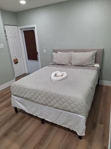 a bed with a white towel on top of it at Casa Del Sol in Lauderhill