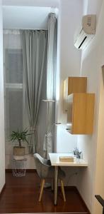 a desk and a chair in a room with a window at Main Square Dream Apartment in Zagreb