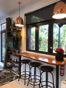 a kitchen with a large window and a counter with stools at Tiny Home Luxury Farm Escape in Egmont Village