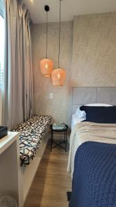 a bedroom with a bed and two hanging lights at Suíte Casal, RioCentro Parque Olímpico Barra da Tijuca in Rio de Janeiro +18 photos