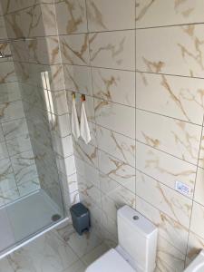 a bathroom with a toilet and a glass shower at Selwyn Stays in Liverpool