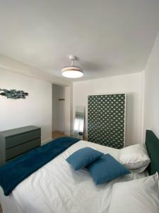 a bedroom with a large bed with blue pillows at ARENA & MAR in El Campello