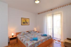 a bedroom with a bed and a large window at Ferienwohnung für 5 Personen ca 70 qm in Stinjan, Istrien Istrische Riviera in Štinjan +14 photos