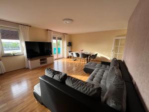 a living room with a black couch and a table at Albert-Schulte-Park Apartment- Worms in Worms