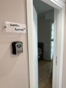 an open door with a alarm clock on it at Camera Manzoni Difronte San Siro in Milan