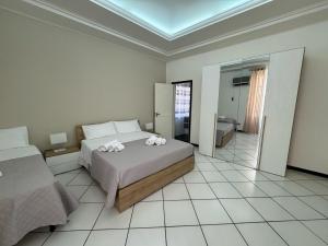 a bedroom with a bed with flowers on it at Angolo Lamia Sicily Apartment in Partinico
