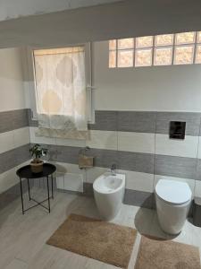 a bathroom with a toilet and a bidet at Casa Vacanze Manzoni 29 in Cagliari