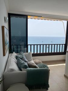 a living room with a couch and a view of the ocean at Sol y Sea Holiday Homes Don Paco in Patalavaca