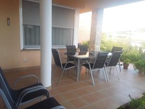 a patio with a table and chairs on a balcony at Casa Laure y Mª José in Arens de Lledó