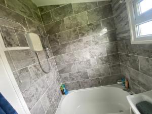 a bathroom with a shower and a bath tub at 348 Golden Sands in Withernsea