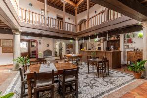 a large room with wooden tables and chairs at El Secreto del Olivo in Nigüelas