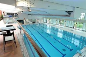 a large swimming pool in a large building at ChezClervie Nanterre City, Close To Paris La Défense U Arena in Nanterre