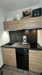 a kitchen with a sink and a stove at Studio la Mongie Tourmalet 2 étoiles in Bagnères-de-Bigorre
