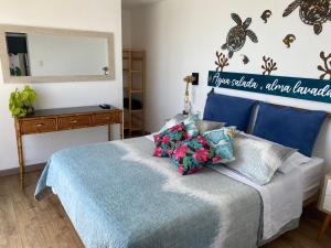 1 dormitorio con cama azul y espejo en frente al mar San Bartolo en San Bartolo