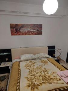 a bedroom with a bed with a painting on the wall at Apartment in quiet neighbourhood in Alimos in Athens