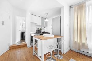 eine Küche mit weißen Wänden und einer hölzernen Arbeitsplatte in der Unterkunft 139-2E west village 1BR best value in New York