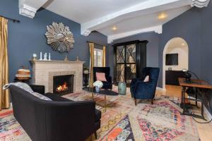 a living room with blue walls and a fireplace at Luxurious Living: Modern 5BR Home, LA's Best Stay! in Los Angeles
