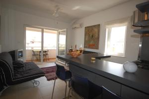 a kitchen with a black counter top and a living room at Ferienwohnung für 4 Personen ca 35 qm in Porat, Kvarner Bucht Krk in Porat
