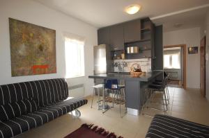 a living room with a couch and a kitchen at Ferienwohnung für 4 Personen ca 35 qm in Porat, Kvarner Bucht Krk in Porat