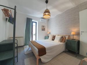 Postel nebo postele na pokoji v ubytování CASA DINA - Fondi Vertice Rooms