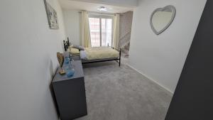 a room with a vanity and a mirror on the wall at Spacious first floor apartment with gorgeous sea views in Weymouth