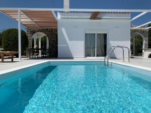 a swimming pool in front of a villa at Ferienhaus mit Privatpool für 6 Personen ca 105 m in Faliraki, Ägäis Rhodos in Faliraki