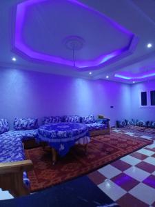 a purple room with couches and a purple ceiling at Dar zahra in Aourir