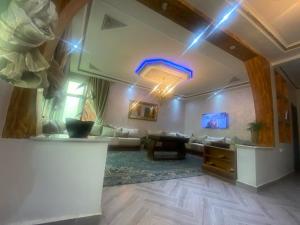 a living room with a couch and a table at Appartement familiale 3 chambres proche de mer in Tangier