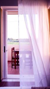an open door to a room with a table and a window at Kamara Apartments Marmari in Marmari