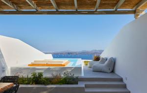 a view from the balcony of a house with stairs at Phos The Boutique in Akrotiri