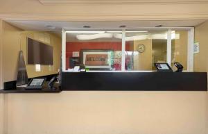 a mirror on the wall of a office with two laptops at Extended Stay America Suites Washington DC Germantown Town Center in Germantown