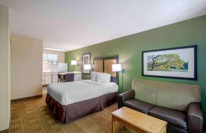 a hotel room with a bed and a couch at Extended Stay America Suites Washington DC Germantown Town Center in Germantown +59 photos
