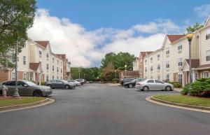 a street with parked cars in a residential neighborhood at Extended Stay America Suites - Atlanta - Norcross - Peachtree Corners in Norcross