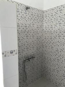 a shower with a shower head in a bathroom at Chez Jacques Diatta in Cap Skirring