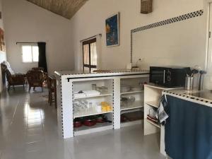 a kitchen with a counter and a dining room at Chez Jacques Diatta in Cap Skirring