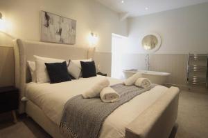 Un dormitorio con una cama grande y una bañera. en Pass the Keys Apartment 4 Old Conservative Club in Historic Town, en Caernarfon