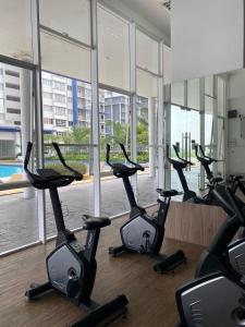 a row of cardio exercise bikes in a gym at Alwafiqah Palmyra Condo 3 Bedroom- With Netflix & Wifi near Bangi, Kajang, Nilai,Putrajaya, KLIA in Kajang