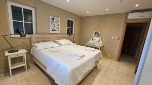 a bedroom with a large bed and a mirror at Red House Apartment With Swimming Pool in Vinišće +27 photos