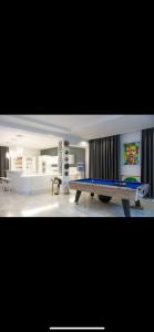 a living room with a ping pong table in it at Sunset view in Cheraga