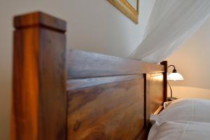 a wooden headboard of a bed in a bedroom at Villa Maslinova Grana in Vabriga