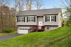 a house with a driveway and a garage at The Mountain View Cottage - Deck and Firepit 6 Mins To River! Perfect For Families in Harpers Ferry
