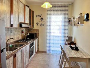 a kitchen with a sink and a stove at Beautiful apartment 100mt from the sea in Porto Torres