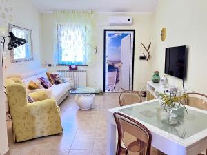 a living room with a couch and a table at Beautiful apartment 100mt from the sea in Porto Torres